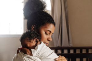 Mother and newborn in nursery, highlighting postpartum depression concerns