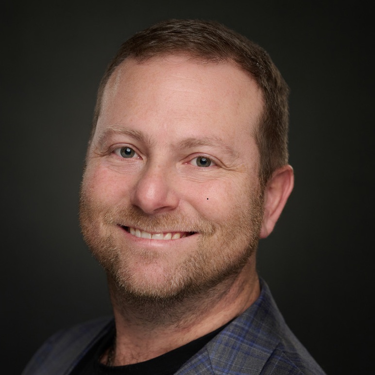 Psychiatrist in clinical setting smiling confidently